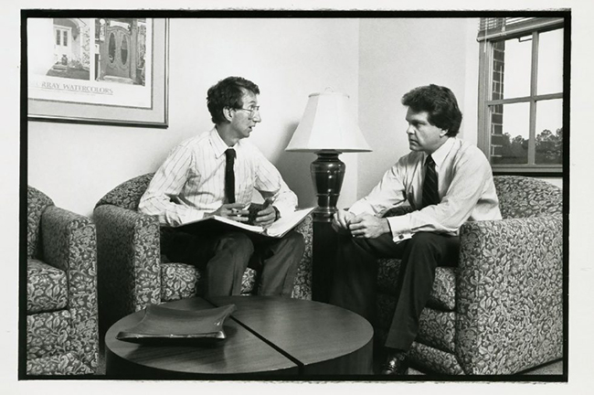 professor james cox and lawrence baxter sitting and talking to each other