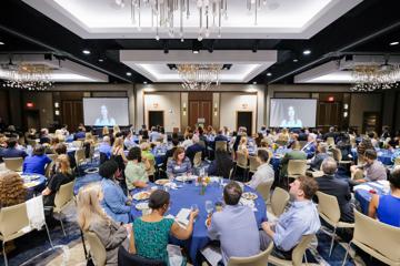 Scholarship donors and recipient talking at brunch table