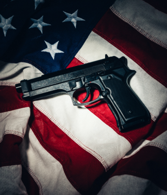 Guns, Violence & Democracy stock image of gun over American flag