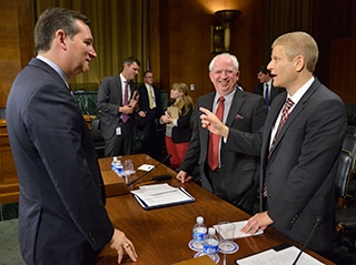 Prof. Neil Siegel, right, chats with Sen. Ted Cruz and Chapman University law professor John Eastman after testifying before the Subcommittee on Oversight, Agency Action, Federal Rights and Federal Courts of the Senate Judiciary Committee on July 22.