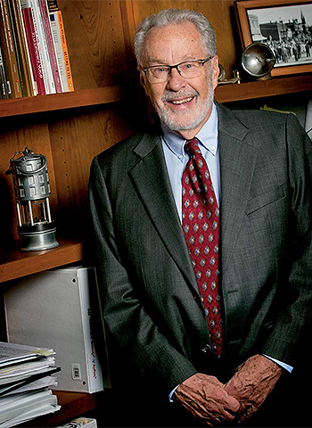 Professor Neil Vidmar keeps mementoes from his coal-mining background, like the miner’s lamp, at left, in his office.