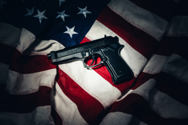 Guns, Violence & Democracy stock image of gun over American flag